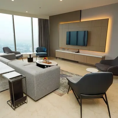 A wide shot of the open-plan living and dining area, emphasizing the floor-to-ceiling windows and expansive city view. This is key for marketing luxury real estate and hotel suites.