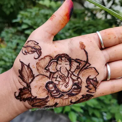 A peaceful Lord Ganesha resting on a hibiscus flower, a popular design for Ganesh Chaturthi. This simple yet detailed portrait is perfect for celebrating the festival.