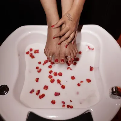 My signature rose petal foot soak is a client favorite. This pedicure treatment is designed for ultimate relaxation, using warm water and natural botanicals to soften your feet before a perfect polish.