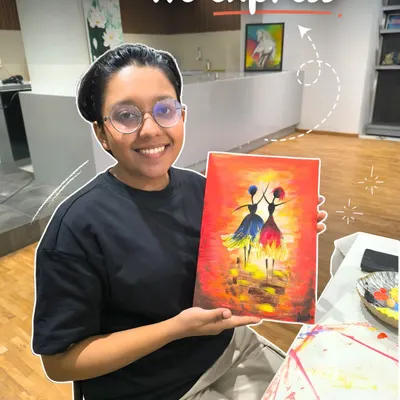 A smiling student proudly displays her colorful painting of two dancing figures, a beautiful piece she created during one of my expressive art classes.
