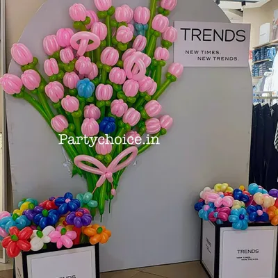 We created this intricate balloon sculpture for the retail brand 'Trends'. The display features a large bouquet of pink balloon tulips on a grey backdrop, with boxes of smaller, colorful balloon flowers, showcasing our custom balloon modelling skills.