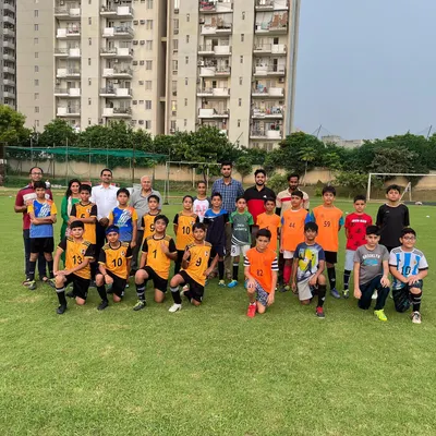 A group photo with both teams after our U-11 friendly match. Competing against other academies helps our players grow and builds sportsmanship.