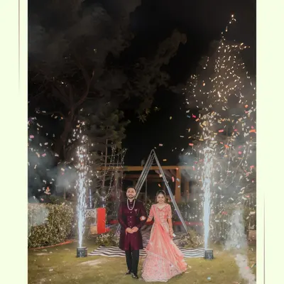 A magical entrance for Alankrit and Parul, walking hand-in-hand through a shower of cold pyrotechnics. We capture the grandeur and excitement of your key moments.