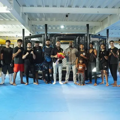 The whole team with "King James," the voice of our fighting championship. Our community extends beyond just our fighters to include everyone who supports our mission.