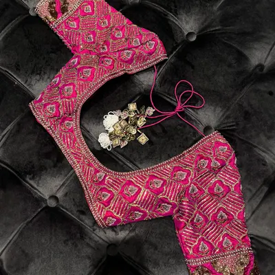 Personalized perfection. This meticulously embroidered pink blouse, with its intricate patterns and rich texture, is designed to elevate your signature style. It is a work of crafted couture.