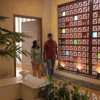 At the Ekta Residence, we designed this stunning `jaali` wall with colored glass inserts. It serves as a beautiful, semi-permeable screen that offers privacy, ventilation, and a dynamic play of colored light.
