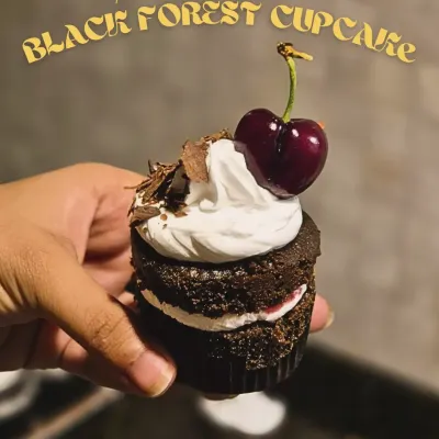 This is what you call a real Black Forest cupcake. A moist chocolate base, a layer of tangy cherry filling, special cream, chocolate shavings, and a fresh cherry on top.