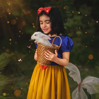 Our little Snow White gently holds a real bunny in an enchanted forest setting. These fantasy sessions are meticulously crafted to create a truly magical, storybook experience for your child.
