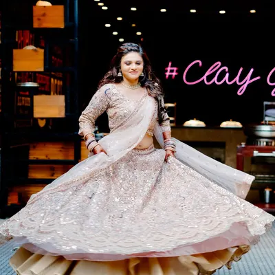 A beautiful full-length shot of the bride-to-be twirling in her shimmering lehenga at her engagement party. We capture the energy and glamour of your celebration.