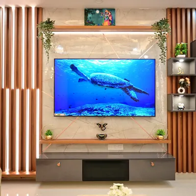 A centerpiece for your living room. This modern TV unit combines sleek marble-finish panels, warm wood accents, and integrated LED lighting to create a sophisticated focal point. The design includes both open shelves for decor and closed cabinets for clutter-free storage.