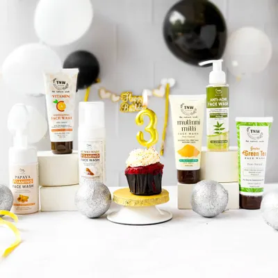 A festive setup for a brand's third birthday celebration. I arranged a variety of their face wash products around a cupcake and balloons to create a fun, celebratory group shot.