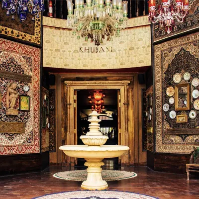 This is the grand entrance to Khubani. With a central fountain, towering Persian carpets, and a symphony of chandeliers, I welcome you into a world of unparalleled opulence.