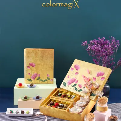 Our golden lotus print book box is a work of art. It opens to reveal a delightful assortment of chocolates and desserts in jars, making for a magical unboxing experience.