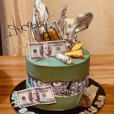 A stylish fault line cake with a money theme, featuring edible dollar bills.