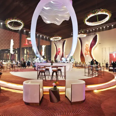 The stage is set for an unforgettable experience. We design grand, immersive environments where every element, from the towering floral rings to the intimate seating, contributes to the magic of the moment.