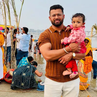 Holding my child during Chhath Puja at the Sangam. My family and my faith are the sources of my deepest strength and teach me the power of devotion.