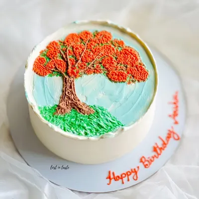 This cake is a tribute to the beautiful Gulmohar tree. The design is hand-piped with colored buttercream to create a miniature painting you can eat.