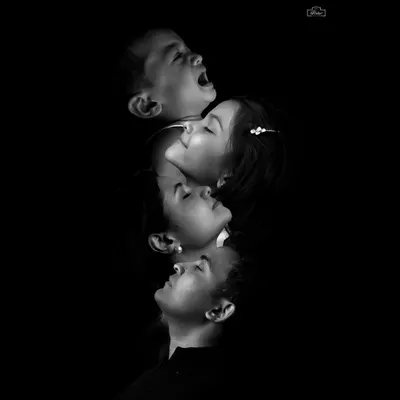 An artistic black and white composition showing the different emotions and profiles within a family. This creative portrait style results in a unique and impactful piece of art.