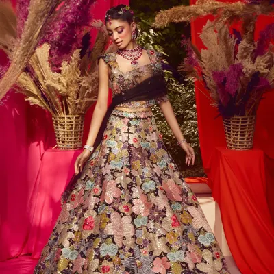 A celebration of bold beauty, intricate artistry and femininity. This look from a campaign shoot features a vibrant purple winged liner and floral details.