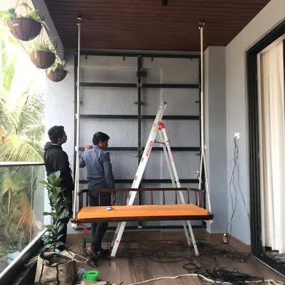 The first step in a balcony project. Here, our team is installing the foundational metal framework that will support the modular grid system for a new vertical garden in Bangalore.