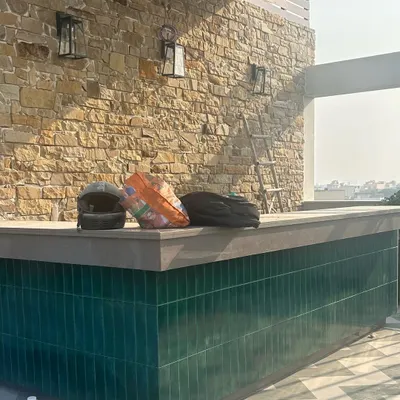 Work lately. An outdoor bar taking shape with a stunning stone wall and emerald green tiles. We can't wait to see this space ready for entertaining.