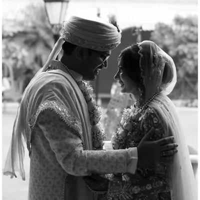 A classic black and white shot from a wedding day. The image freezes a quiet, intimate moment between the couple, their expressions telling a story of love and happiness. This is the kind of timeless memory I strive to capture.