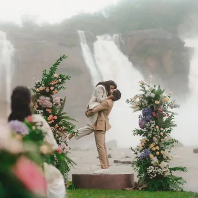A kiss that feels as powerful as the falls behind them. This shot from Gokul and Vandana's vow renewal at Athirappilly shows how we can create a truly epic moment, framed by nature's grandeur and beautiful floral decor.
