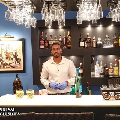 One of my professional bartenders ready for service at a private event. I provide a complete bar setup, including glassware, premium spirits, and skilled staff to manage all your beverage needs.