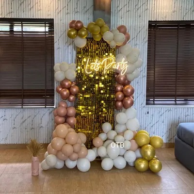 This is the same popular 'Let's Party' setup with a gold sequin wall and pastel balloon garland, shown here in a home setting. It's a versatile backdrop that works for any modern celebration.