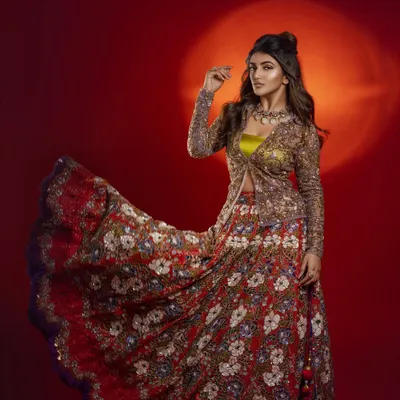 Styling actress Sreeleela in a vibrant, floral-embroidered lehenga with a matching jacket. The look was for a magazine feature, and I aimed for a playful yet regal aesthetic against a bold red background.