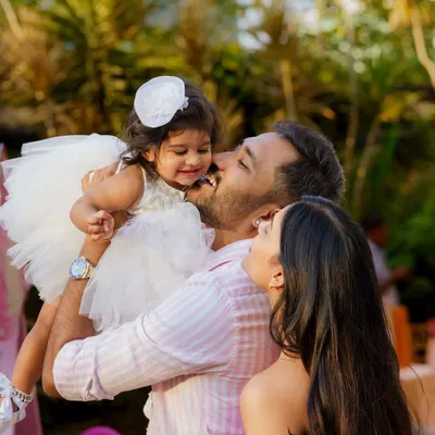 A moment of pure love and affection. We quietly observe and capture these candid interactions between parents and their children, as they are often the most powerful and emotional images from the day.