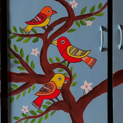 A detailed shot of the hand-painted cupboard. This close-up shows the folk art style of the birds, with their patterned wings and bright colors set against the calm blue background.
