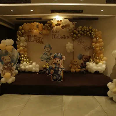 We can "bearly wait." This adorable teddy bear-themed baby shower stage features a neutral color palette of brown, gold, and white, perfect for a gender-neutral celebration.