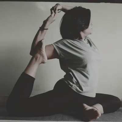 Practicing Rajakapotasana (King Pigeon Pose). This advanced asana is a deep hip and heart opener that improves spinal mobility, reduces stress, and stimulates digestion.