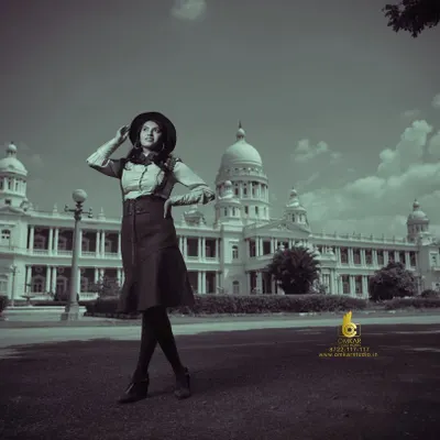A wide-angle shot from our vintage fashion series, placing the model against the grand backdrop of a Mysore landmark. The desaturated, black and white treatment gives this image a timeless, old-world feel, perfect for an editorial story.