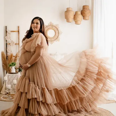 This gorgeous mom-to-be looks like a goddess in this tiered, ruffled gown. We shot this in my studio's boho-themed setup, which adds a warm, earthy feel to these glamorous maternity portraits.