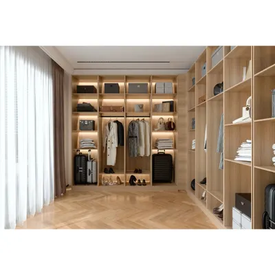 A spacious walk-in wardrobe we designed with custom wooden shelving and compartments. The layout is organized to accommodate clothing, shoes, and luggage, with integrated lighting to illuminate the space.