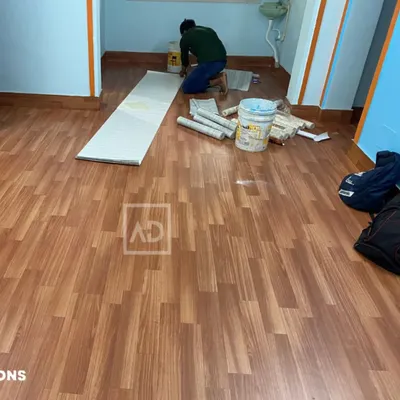 This photo shows a PVC wooden flooring installation in progress. This type of flooring is durable, water-resistant, and provides the look of real wood at a more accessible price point.