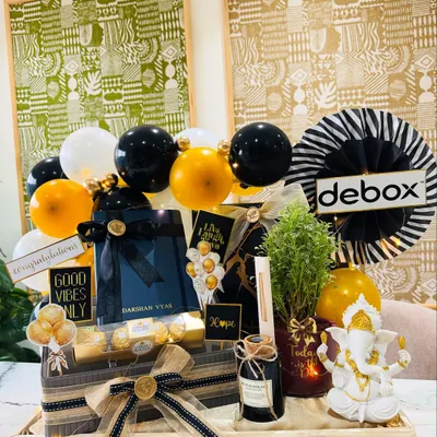 A full view of our 'New Beginnings' hamper, created for a son-in-law's office inauguration. The client wanted something elegant and masculine, so we built this arrangement with a Ganesha idol, a live Arailia plant, and a personalized diary, all in a striking black and gold palette.