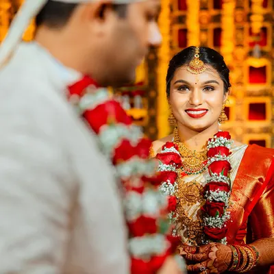 A candid moment during a South Indian wedding ceremony. The bride's joyful expression as she looks at her groom is the kind of genuine emotion I strive to capture, framed by their beautiful floral garlands.