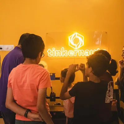 A typical scene from one of our workshops, with students gathered around a 3D printer, watching their digital designs become physical objects. We create an environment of shared discovery and excitement.