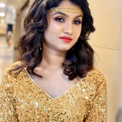 A full glamour look for a model shoot, featuring shimmering gold eyeshadow, sharp winged liner, and a classic red lip. The look is bold, confident, and perfect for a party or event.