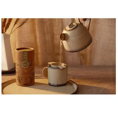 An action shot capturing the moment of pouring hot water to brew tea. This image tells a story of preparation and mindfulness, highlighting both the product and the experience.