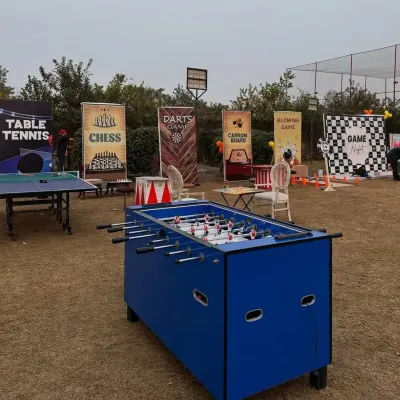 We can set up a complete game zone for your event. This outdoor arrangement for a pre-wedding party included table tennis, foosball, a carrom board, a chess station, and a darts game, offering something for everyone.