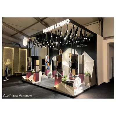 For Pllum Legno's 15 sq.m stall, we created an art installation instead of a traditional pavilion. This side view shows the dramatic lighting and sculptural display stands set against an abstract, faceted background.