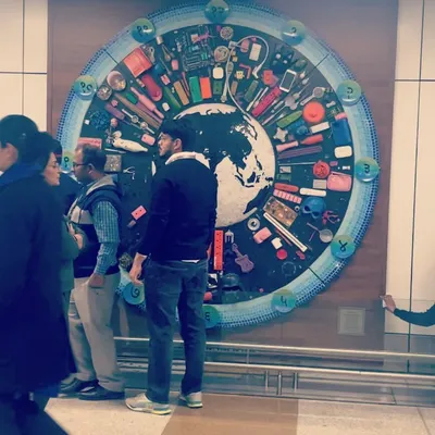 The finished mural installed at the airport, seen by people from all over the world. It is designed to make people pause and think about consumption and the environment, even in a busy travel hub.