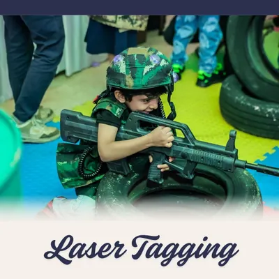 Get ready for battle! A young guest geared up for a game of laser tag, complete with a helmet and vest. I can set up a full laser tag arena for an adrenaline-pumping party experience.