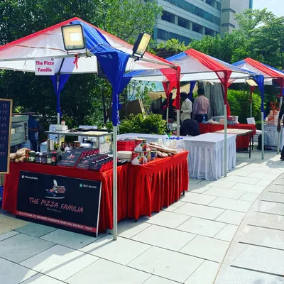 Our live food stalls set up for a corporate event at Candor Techspace. The red, white, and blue canopies create a professional and inviting look for employees and guests.