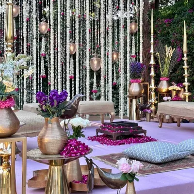 This beautiful vedi, with its lavender platform, brass accents, and a curtain of fresh flowers, has my whole heart.