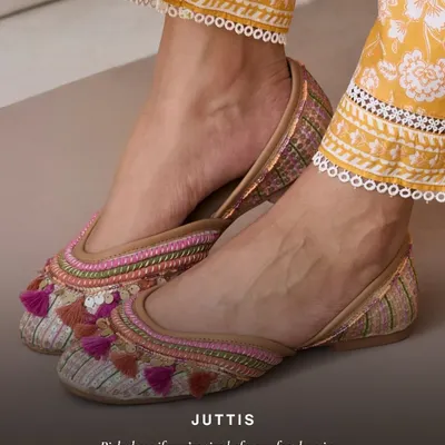 If you're tired of your feet hurting, these are for you. This pair of juttis features colorful threadwork and fun tassels, adding a playful touch to your ethnic wear while promising all-day comfort.